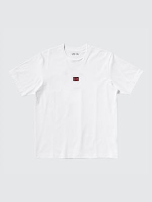 white t-shirt with a small red square on the front saying dandadan.