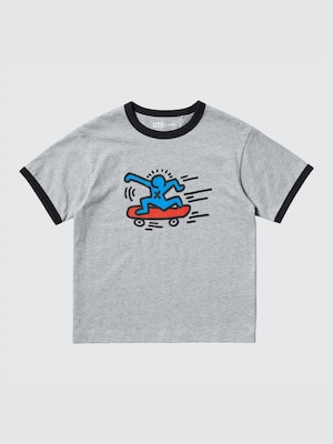 grey t-shirt with a blue stickfigure riding a red skateboard on the front.