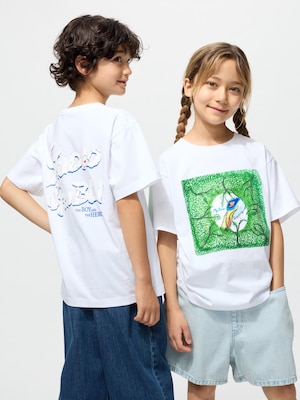 white t-shirt with a large green the boy and the heron graphic on the front and a studio ghibli logo on the back.