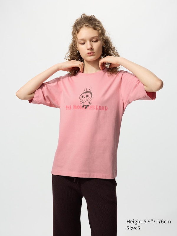 Pink T-shirt with a labubu sitting on the monsterland text on the front.