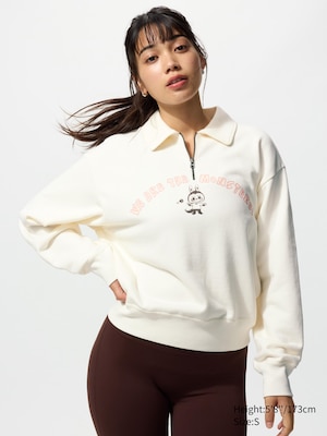 long sleeved beige sweatshirt with a labubu on the front and text saying we are the monsters!